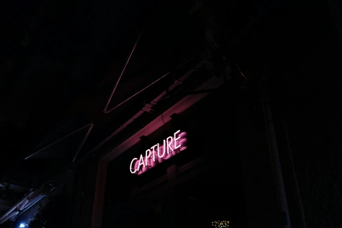 a neon sign is lit up in the dark